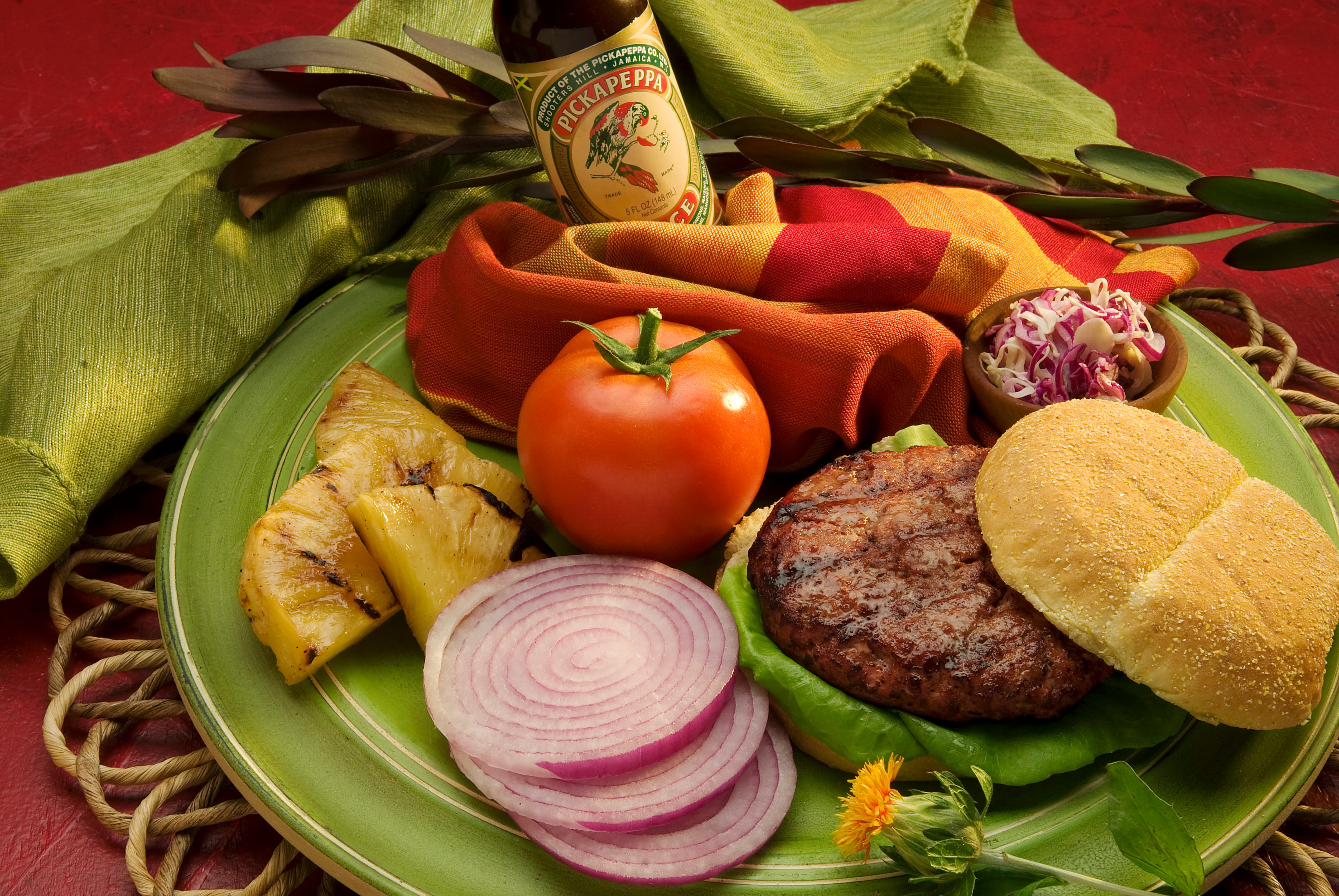 A grilled burger served with Pickapeppa Sauce