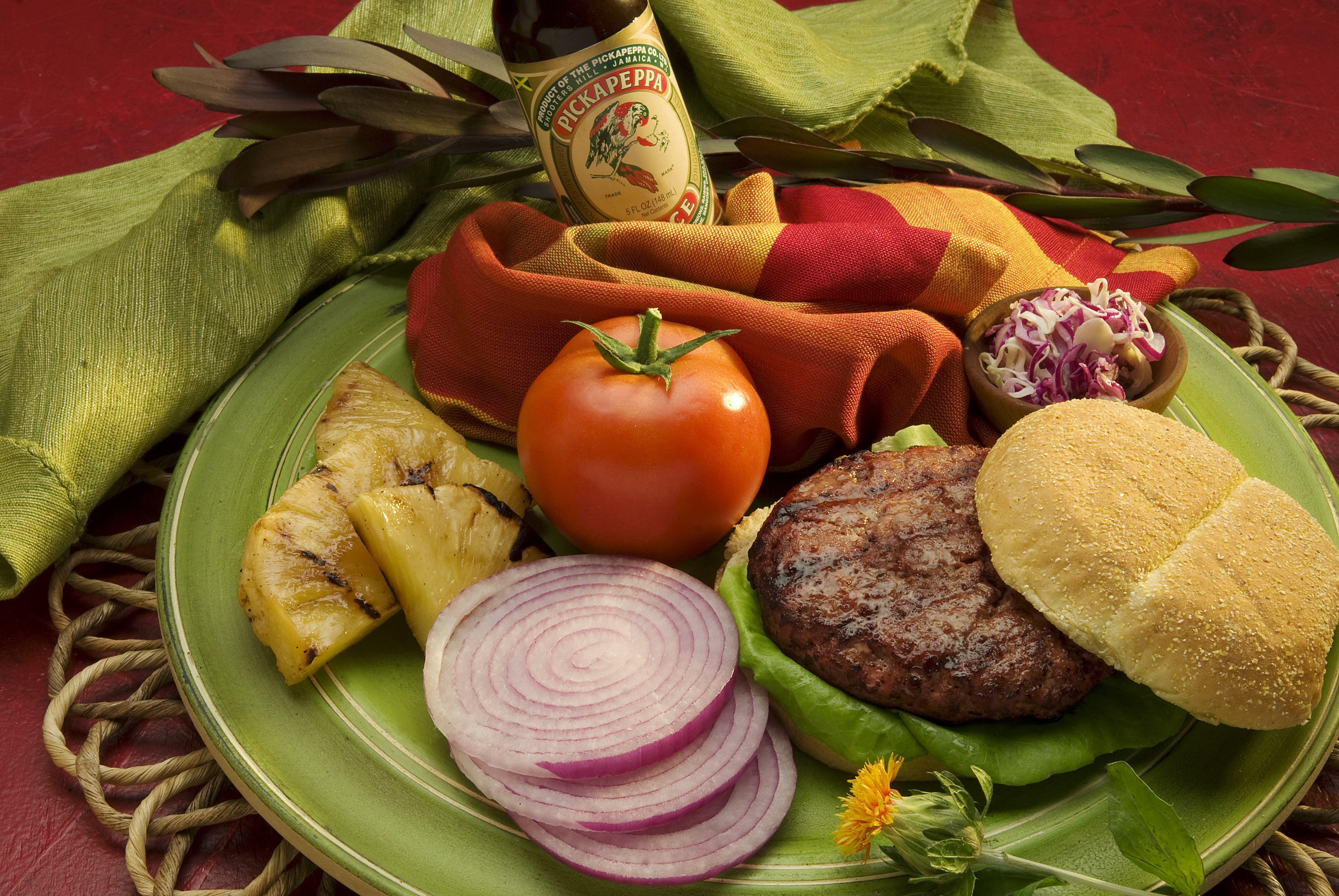 A grilled burger served with Pickapeppa Sauce